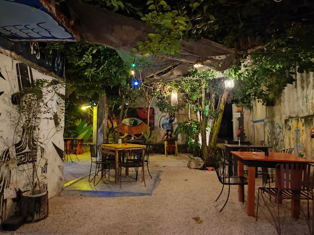 El Apapacho's garden dining area with bougainvillea in Mérida's Centro