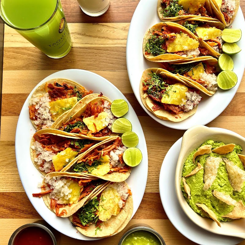 Elegant interior of La Once Mil – Taquería highlighting a premium rib‑eye taco on a polished plate