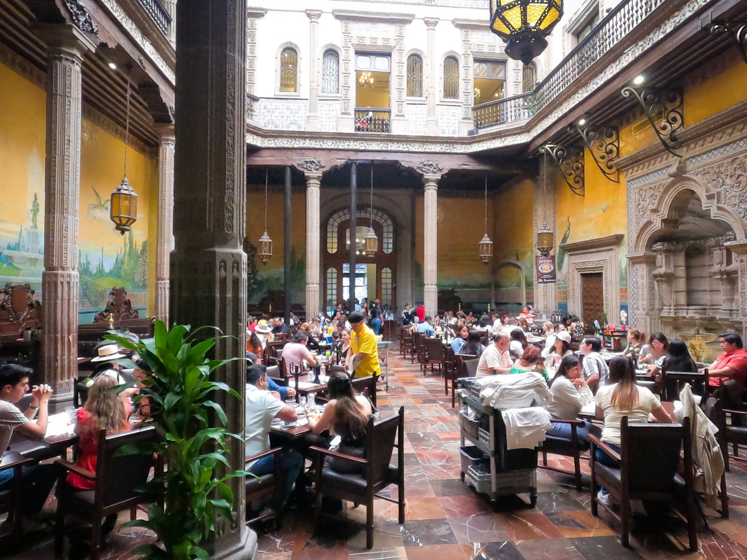 a restaurant filled with lots of people sitting at tables