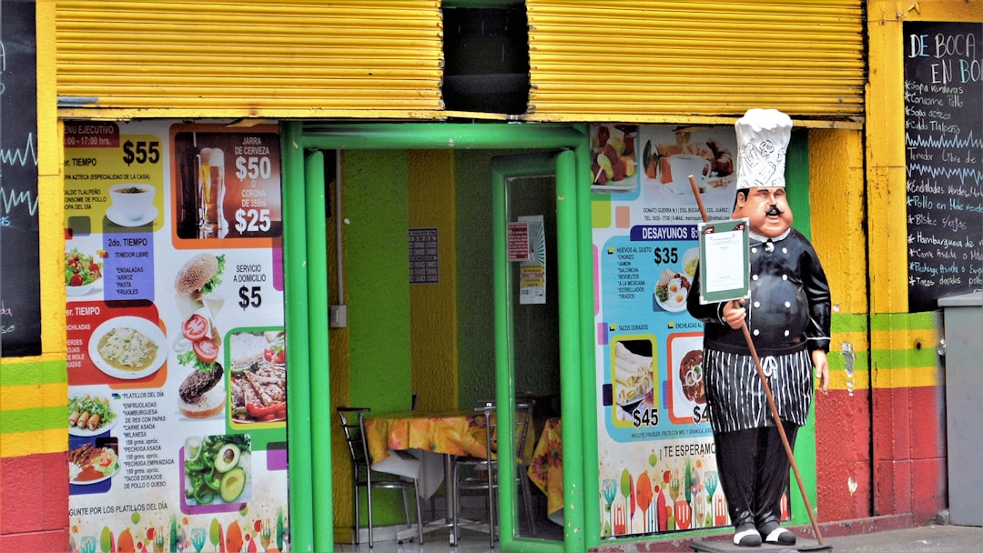 woman in black and white stripe shirt standing beside green and white wooden door