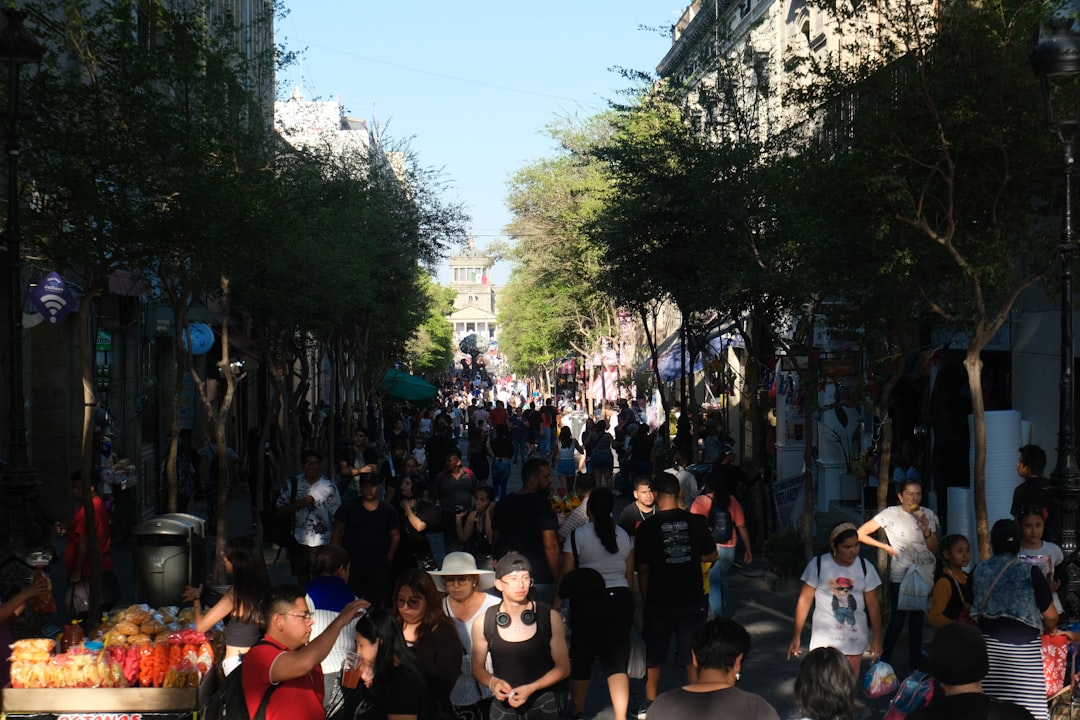 Crowded street with many people walking.
