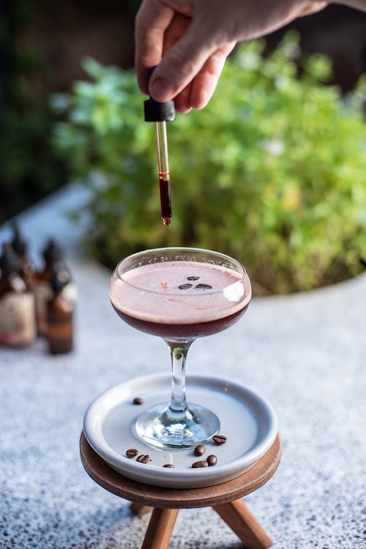 Bronson’s shaded patio with a mezcal cocktail and fig tree