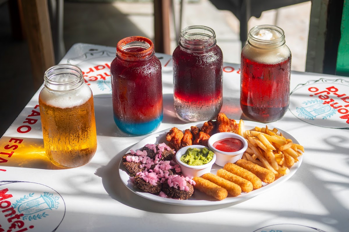 La Negrita Cantina storefront on Calle 62 at dusk, turquoise paint and swinging sign, with warm interior light visible