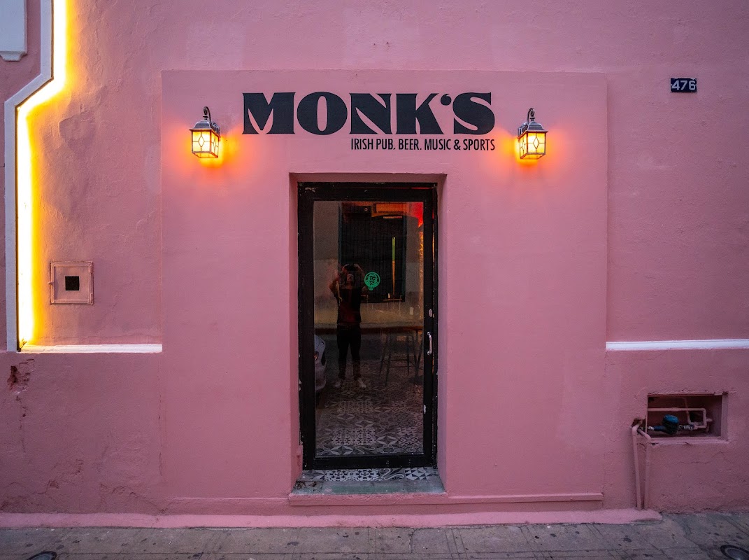 Lapa Lapa exterior with neon sign and patio, showing bar area and grill under evening lights
