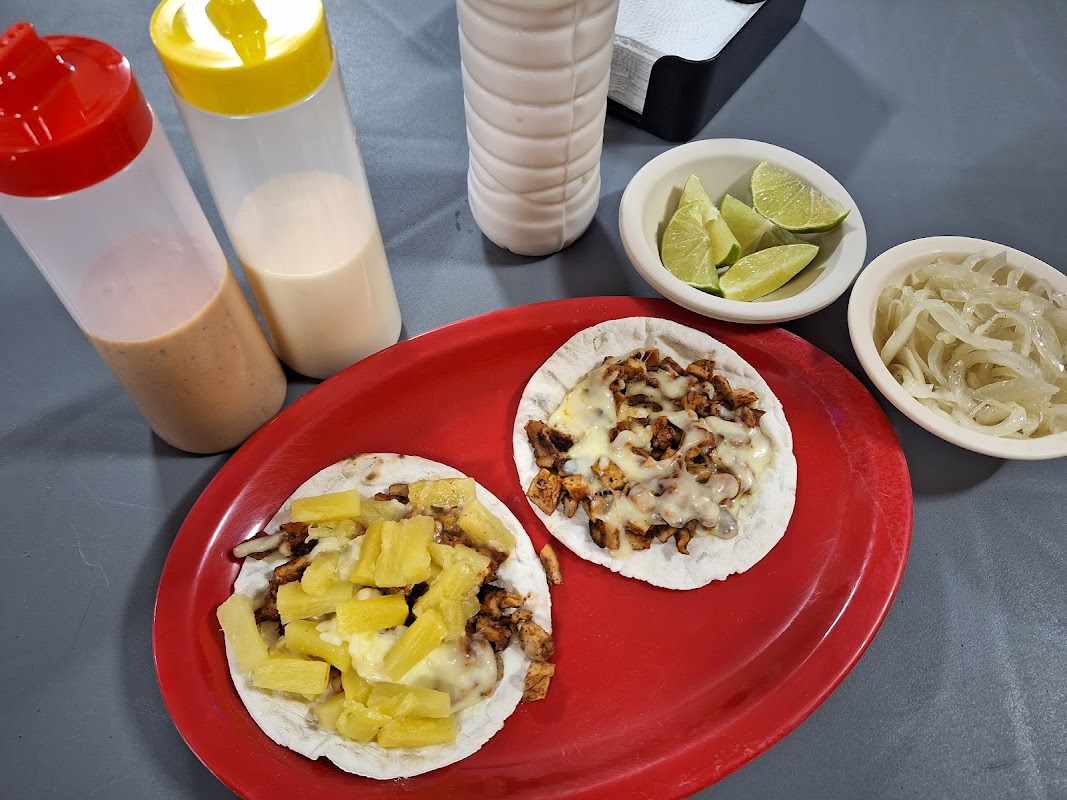 A bustling kitchen at Taquería Yucatán, steam rising from a cast-iron comal