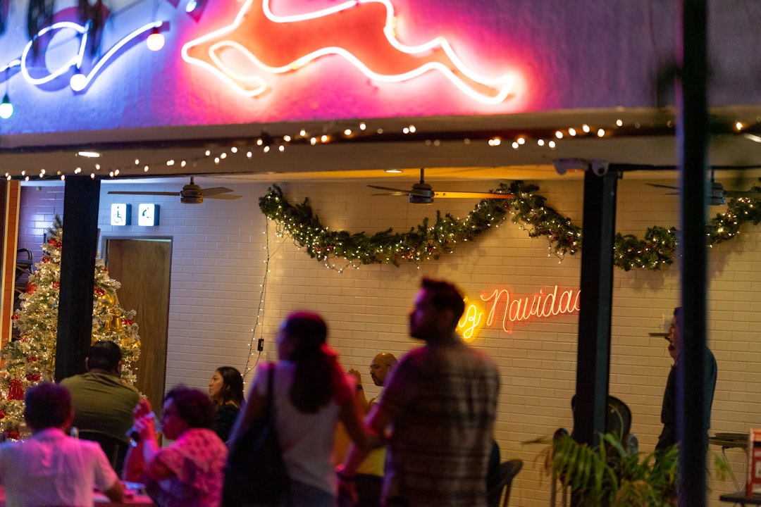 A christmas-themed restaurant at night with people.