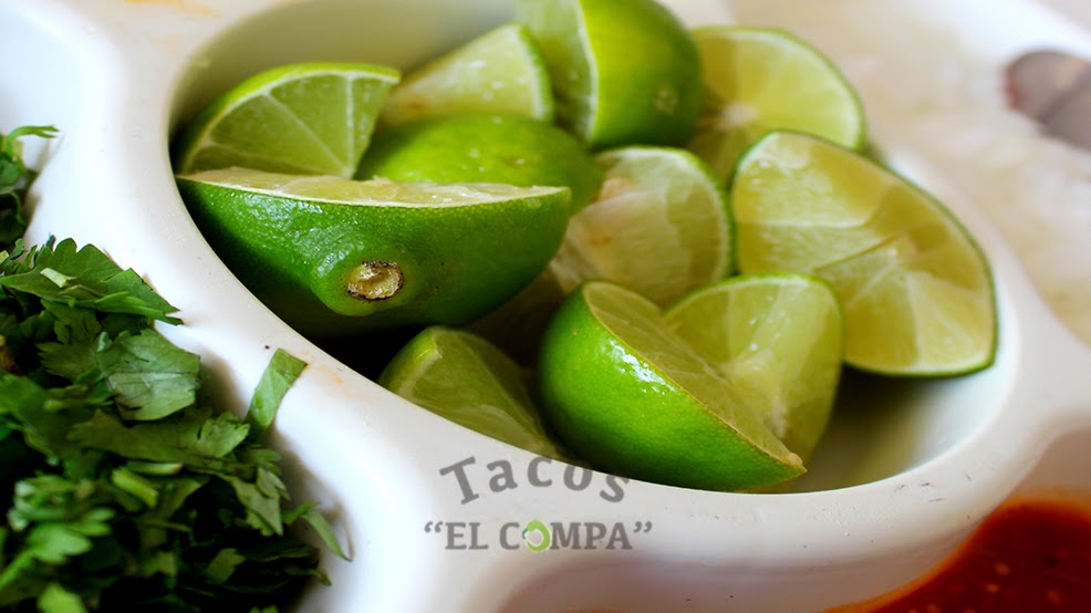 Tacos El Compa’s red awning and bustling line during lunch
