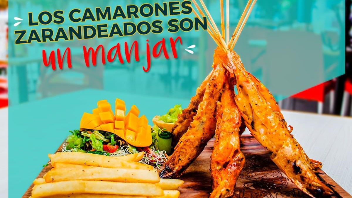 Mariscos Cocos Locos – close-up of a bowl of aguachile on the bar, lime wedges and cilantro visible