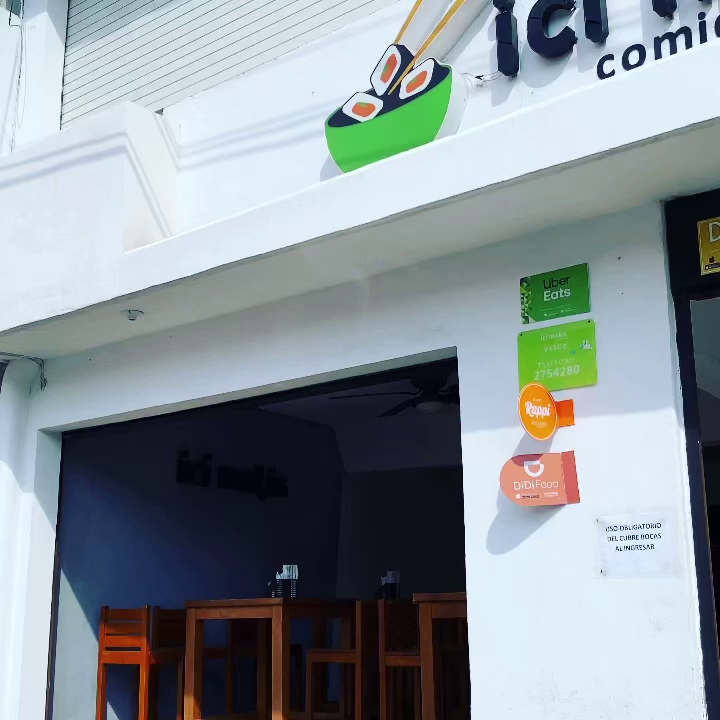 Magari Cafetería Japonesa storefront with neon sign, wooden interior, sushi bar and patrons enjoying karaoke