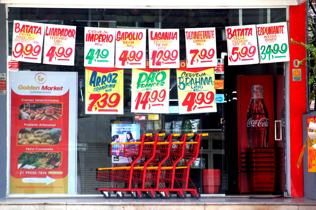 A grocery store window displaying price tags.
