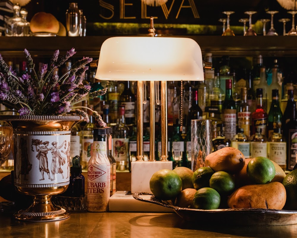 REPÚBLICA COZANA – bustling plaza setting with a margarita glass front and a crowd of locals chatting