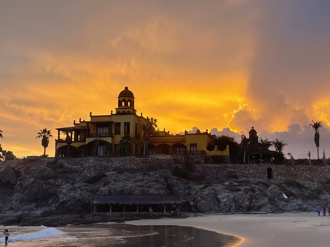 a building on a rocky beach
