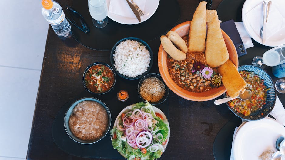 Colorful Mexican meal spread with rice, salad, and breaded fish. Perfect for gastronomic exploration.