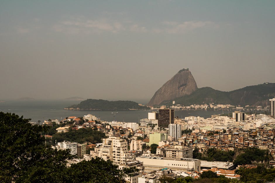 Aerial view of Rio de Janeiro highlighting the iconic Sugarloaf Mountain and urban landscape.