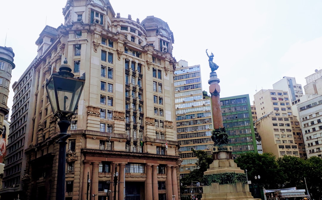 a tall building with a statue in front of it