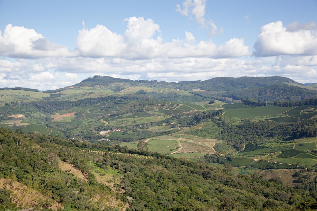 a view of a lush green valley surrounded by mountains