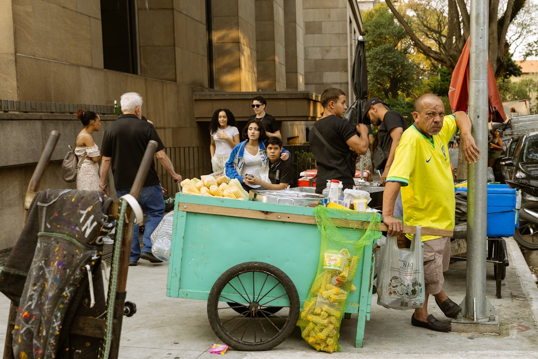 A group of people standing around a table filled with food